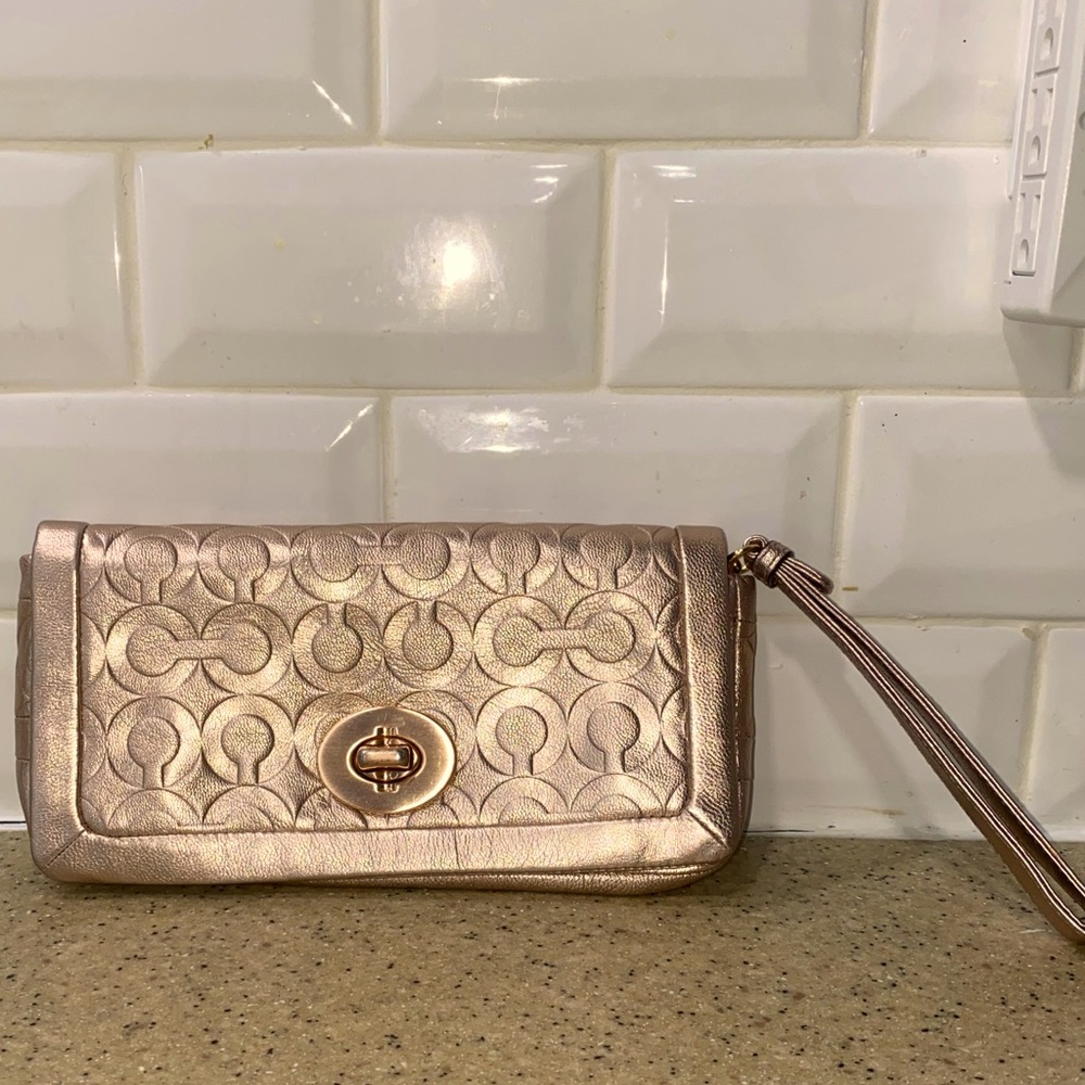 COACH: Rose gold clutch